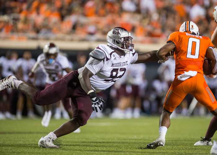 Sep 4, 2021; Stillwater, Oklahoma, USA; Missouri State Bears defensive lineman Eric Johnson (93) reaches out to try and stop Oklahoma State Cowboys running back LD Brown (0) during the third quarter at Boone Pickens Stadium. Oklahoma State Cowboys beat Missouri State Bears 23-16.